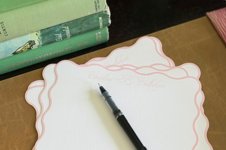 A collection of personalized thank you note cards displayed on a desk. 